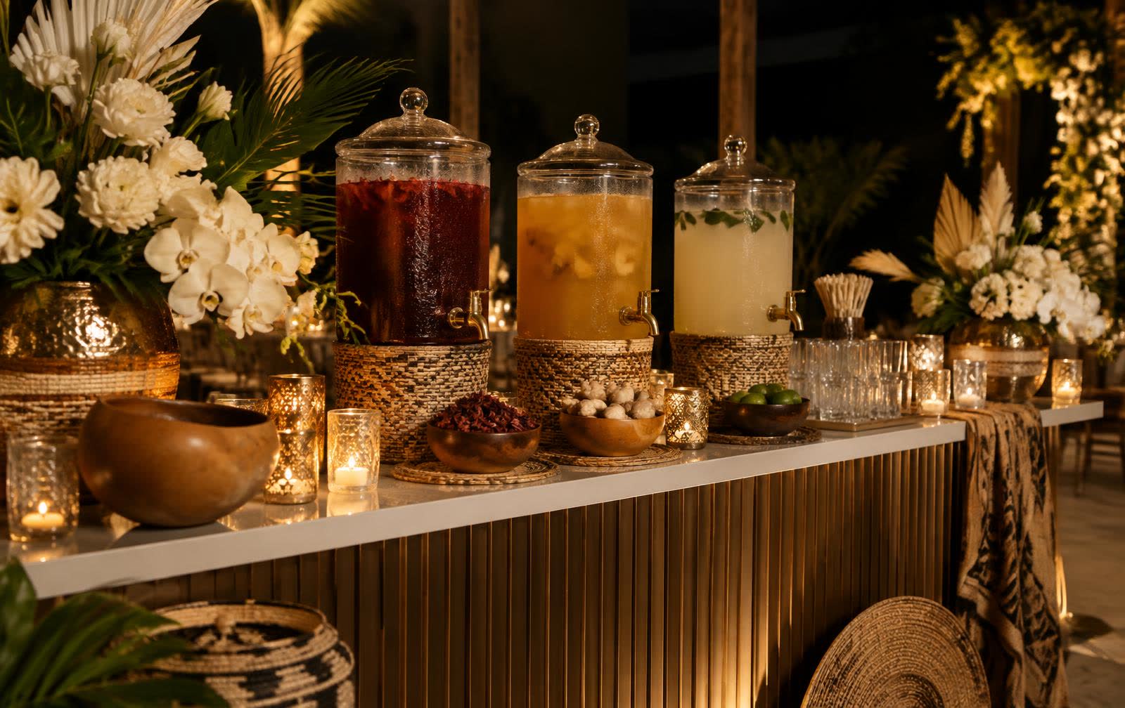 Styled drinks bar with glass dispensers, woven details and white florals