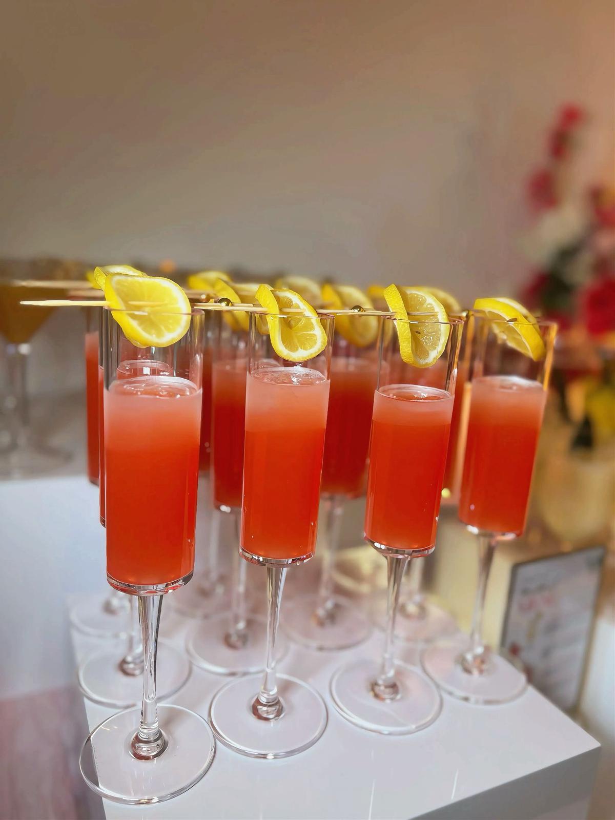 Cocktail hour drinks display alongside canapés